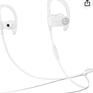 White powerbeats3 Bluetooth headphones with charger